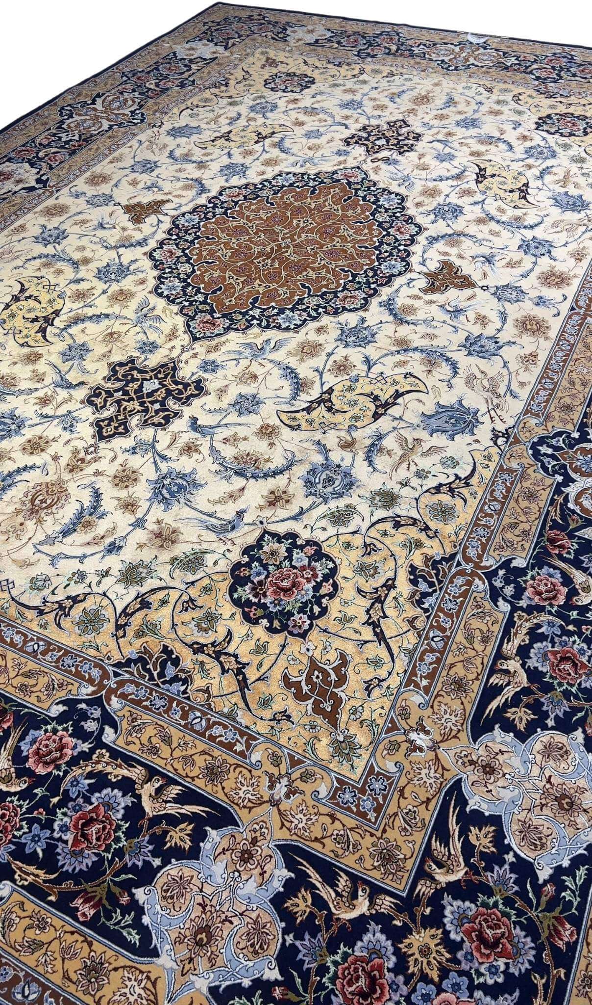 "Golden Isfahan rug with a deep blue border and detailed floral designs, handwoven by Master Hassan Dardashtie."